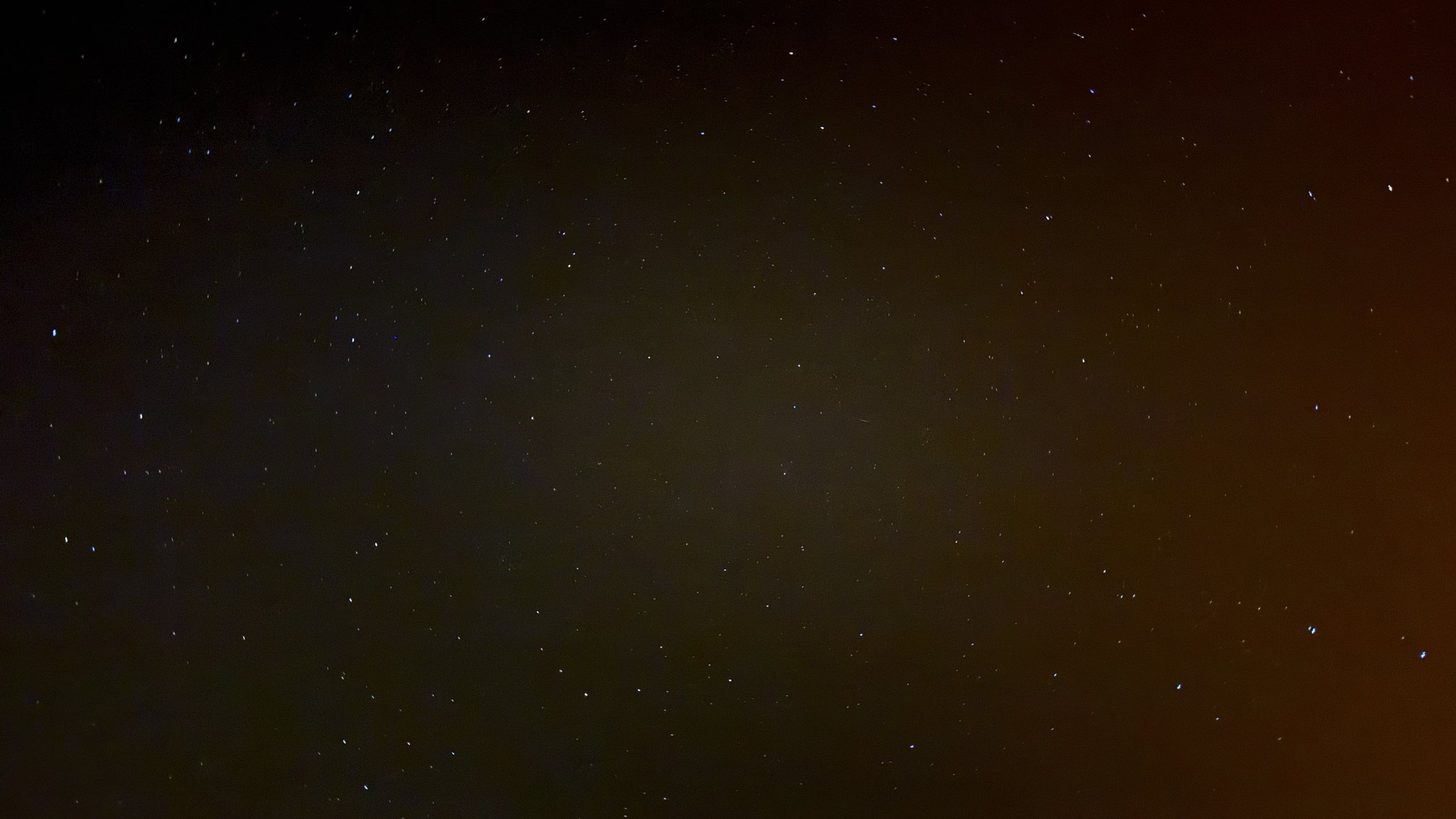An ordinary phone photo of the night sky: faint stars scattered on a
                  near-black background, nothing labelled.